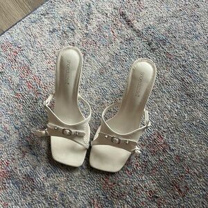 White heels with buckle feature